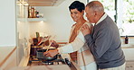 Food, cooking and a mature couple in the kitchen together, bonding while in their home to prepare a meal. Dinner, love or smile with a happy senior man and woman getting cuisine ready for nutrition