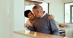 Laughing, hug and a senior couple cooking, talking and bonding in the kitchen. Happy, house and an elderly man and woman with care, conversation and jokes together while making lunch or dinner