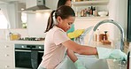 Mom, girl and washing dishes at sink, gloves and faucet with water, hygiene and teaching for life skills. Family home, mother and daughter with cloth, soap and splash for bacteria, dirt and cleaning