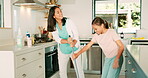 Cleaning, mom and girl dance in the kitchen with a broom, sweeping and or fun housework with music in family home. Kid, learning to clean floor and mother with happy and excited energy in house