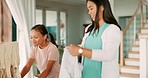 Happy, help and a mother and child with laundry, cleaning and care for clothes in a house. Smile, family and a young mom and a girl kid folding wardrobe clothing in the morning together and learning