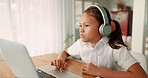 Girl kid, laptop and education with headphones, typing and focus for study, development and home school. Child student, computer and audio tech e-learning with mindset, listen and assessment in house