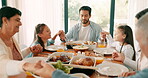 Children, parents and grandparents praying at thanksgiving together as a family for bonding or eating food in celebration. Love, lunch or brunch with kids and relatives saying grace in a dining room
