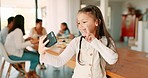 Selfie, peace or social media and a girl in a home, posing with her family on a blurred background. Kids, profile picture and hand gesture with a happy young female child taking a photograph