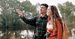 Hiking view, couple and hug on adventure by a lake together with a smile on travel and journey. Happy, young people and outdoor holiday in nature while walking on vacation with freedom and talk