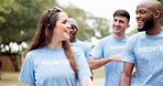 Happy group, volunteer and walking in park for community service, job or NGO in the nature outdoors. Diversity or people in team discussion or social for mission, support or trust together outside