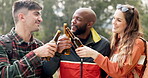 Friends, cheers and group of people with beer at party together in a forest happy and laughing in the woods. Vacation, travel and portrait of excited men on an adventure with love, care and joy