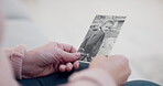 Senior woman, holding and photo with memory with hands and remembering a child in closeup. Retirement, history and elderly person with retro picture in home with nostalgia or thinking about past.