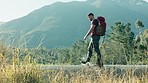 Walking, water or man hiking in nature to explore outdoors for camping on holiday vacation or adventure. Traveller, water or hiker with backpack equipment for travel, break or journey by mountains 