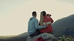 Hiking, view of mountain and couple drinking water, relax on outdoor adventure and freedom in nature from back. Trekking, rock climbing and love, man and woman with bottle, sunset travel and peace.