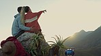 Hiking, mountain and view, happy couple hugging and relax on outdoor adventure, peace in nature. Trekking, rock climbing camp and love, man and woman looking at sunset sky sitting on cliff together.