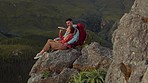 Hiking, mountain and drinking water, couple relax on outdoor adventure and peace in nature with romance. Trekking, rock climbing and love, man and woman with view of natural cliff with sharing drink.