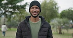 Smile, travel and portrait of man in a park for a outdoor break, vacation or holiday in winter camping site. Indian, tourist and young male person relax in nature for an adventure or to explore