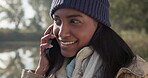 Phone call, camping and woman talking with contact about vacation or holiday location in a forest or the woods. Smile, online and young person speaking on a travel mobile conversation in the morning