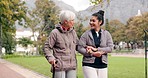 Senior woman, walker and nurse talking in a park with healthcare for elderly exercise. Walking, healthcare professional and female person with peace and physical therapy in a public garden with carer