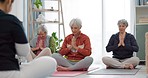 Senior women, yoga group and coach in meditation, peace and prayer hands in exercise, holistic wellness and mindfulness. Spiritual workout, class and calm elderly people, clients and personal trainer