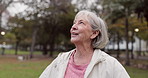 Senior woman, thinking and outdoor at the park to breathe fresh air in nature or woods on walk in retirement. Happy, face and elderly person with wellness, happiness and positive mindset or gratitude