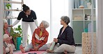 Senior woman, exercise group and personal trainer on floor, home and talk for training advice, workout or health. Elderly lady, team and fitness coaching with chat, drinking water and relax in house