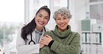 Happy, care and face of a doctor with a woman for medical trust, healthcare and help. Laughing, hug and portrait of a young nurse with a senior patient and love during a consultation at a clinic