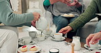 Hands, tea party and senior friends in the living room of their home together for a visit during retirement. Wellness, relax and reunion with a group of elderly people sitting on a sofa in a house