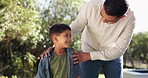 Talking, father and son outdoor, smile and quality time with happiness, bonding and loving together. Family, male parent and child in a park, kid and boy with his dad, conversation and fun outside