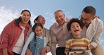 Family, face and happy laughing in summer with bonding on vacation with blue sky and smile. Grandparents, kids and parents on holiday outdoor in nature with senior people and children with care