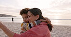 Beach, mother and child hug outdoor on family vacation, holiday or adventure at sunset. Woman and a boy kid embrace and pointing at ocean for quality time with love, comfort and care in nature