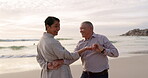 Senior couple, beach and dancing outdoor at sunset with love, care and quality time on travel. Happy man and woman together at ocean to celebrate retirement holiday, fun energy or vacation in nature