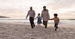 Walking, children and grandparents holding hands at beach for fun vacation, holiday or adventure at sunset. Senior man, woman and kids together at ocean for family time with love outdoor in nature