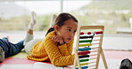 Math, education and child counting for learning numbers doing homework as development with a colorful toy. Mathematics, assessment and kid or girl with knowledge on a kindergarten school floor