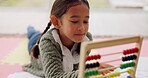 Math, assessment and kid counting for learning numbers doing homework as development with a colorful toy. Mathematics, education and child or girl with knowledge on a kindergarten school floor