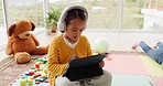 Elearning, child with headphones and tablet in apartment for kindergarten online class and video for education. Home school, digital classroom and small girl learning with internet app for studying.