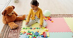 Girl child, building blocks and puzzle on floor, thinking or development for problem solving skills at kindergarten. Young kid, toys and ideas for education, mindset or focus for progress in learning