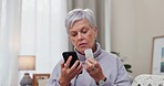 Medicine, research and senior woman with phone on a bed for ingredient, symptoms or warning label in her home. Smartphone, pills and elderly female reading tablet information online in her bedroom
