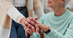 Senior woman, caregiver and holding hands in care, support or trust together in retirement or old age home. Closeup of elderly female person with cane and nurse in grief or loss on living room sofa