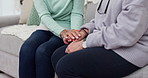 Senior woman, friends and holding hands in support, care or trust together in retirement or old age home. Closeup of elderly female person touching in grief, loss or counseling on living room sofa