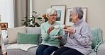Senior women, friends and toast with tea, party and happy for celebration, love or bonding on sofa in retirement. Group, elderly lady and helping hand from young carer, nursing home or relax on couch