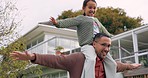 Playing, father and child on shoulder outdoor in a backyard with a smile, happiness and love. Portrait of a happy man and girl kid together for fun game, quality time and family bonding at a house