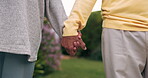 Holding hands, love and couple in nature with care, support and loyalty for marriage commitment, trust and partnership. Together, man and woman in romance on date, bonding and quality time outdoor.