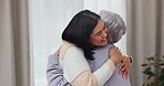 Happy, hug and mother and daughter in a house for a visit, bonding and love in a nursing home. Smile, family and a senior mom with a woman, care and gratitude in a living room together in retirement