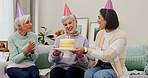Birthday party, cake or thank you with a senior woman with her friends in the home living room for a surprise. Celebration, applause and milestone with an elderly person enjoying a retirement event