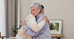 Love, support and empathy with senior friends hugging in a home to console during pain, loss or grief together. Trust, care and unity with elderly women embracing in comfort during retirement