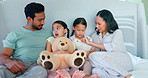 Bed, happy family and parents with love for children and playing with a teddy bear toy together in a bedroom. Care, mother and father bonding with kids in a room for support, morning and security