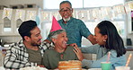 Senior family, birthday party and woman for celebration, kiss and love or support for retirement in home kitchen. Interracial people, elderly parents and happy women or men with cake for holiday