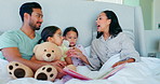 Bed, happy family and parents reading with children and playing with a teddy bear toy together in a bedroom. Care, mother and father bonding with kids in a room for support, morning and security