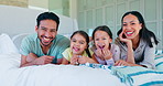 Face, family and funny with children in bedroom, bonding together and care in home. Portrait, mother and kids with father in bed to relax, happy for quality time and laughing in the morning in house