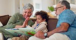 Grandparents, child and high five for reading books on sofa, learning and language development in living room. Happy grandma, grandfather and support boy kid for storytelling together in family home