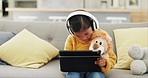 Tablet, headphones and girl or child learning, home education and listening to translation or education audio on sofa. Teddy bear, online games and kid with digital technology web or music streaming