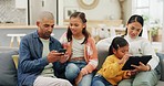 Technology, bonding and parents with their children on a sofa to relax in the living room at home. Happy, love and young father and mother with their kids networking on a cellphone and digital tablet