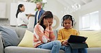 Parents fighting, children cover ears and headphones for noise, sad and sibling helping for mental health on sofa. Mom, father and girl kids with tablet, sad or frustrated for conflict in family home